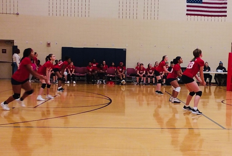 Girls in red shirts playing volleyball